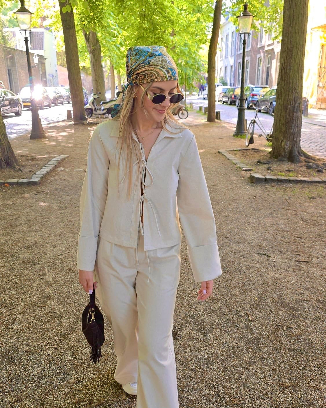 Blouse beige en coton-lin à manches longues avec poignets larges. Coupe droite légèrement courte avec des liens à nouer à l’avant.
