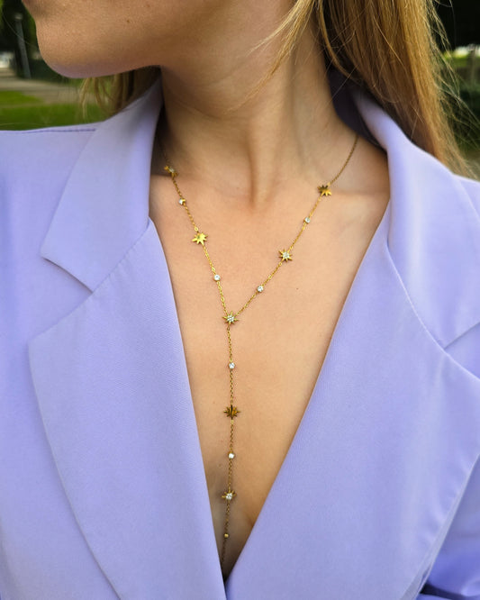 Collier doré en Y. Avec des strasses en formes d’étoiles. Longueur décolleté. 