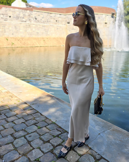 Robe dorée satinée avec volant au buste. Bandé anti-glisse. Longueur maxi.