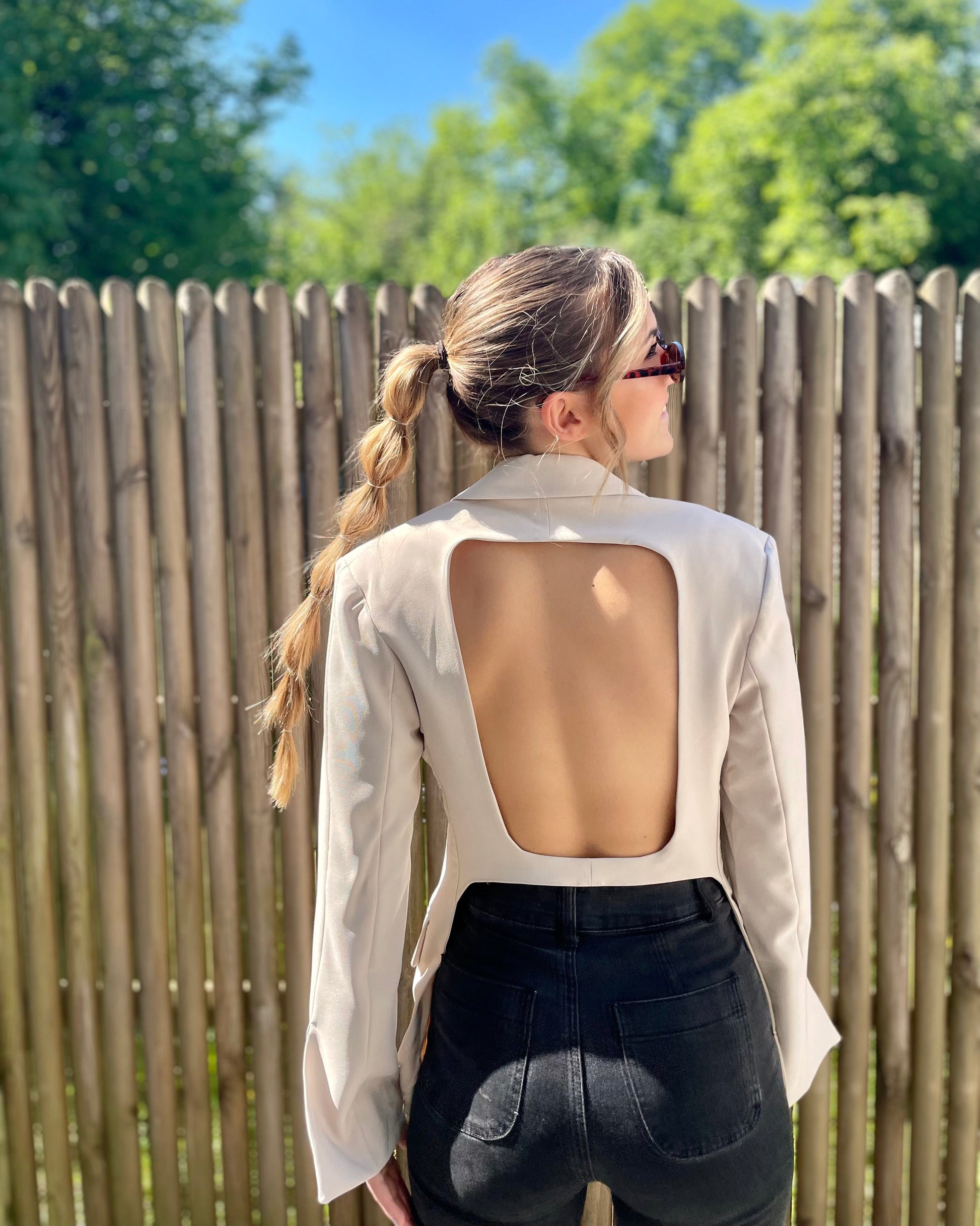 Blazer beige dos un et cintré à la taille. Manches longues et légèrement évasées. 